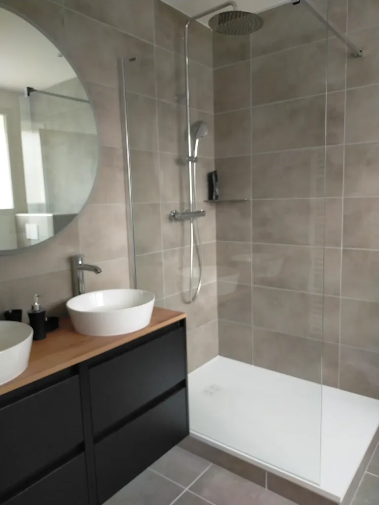 Salle de bain lumineuse et bien équipée